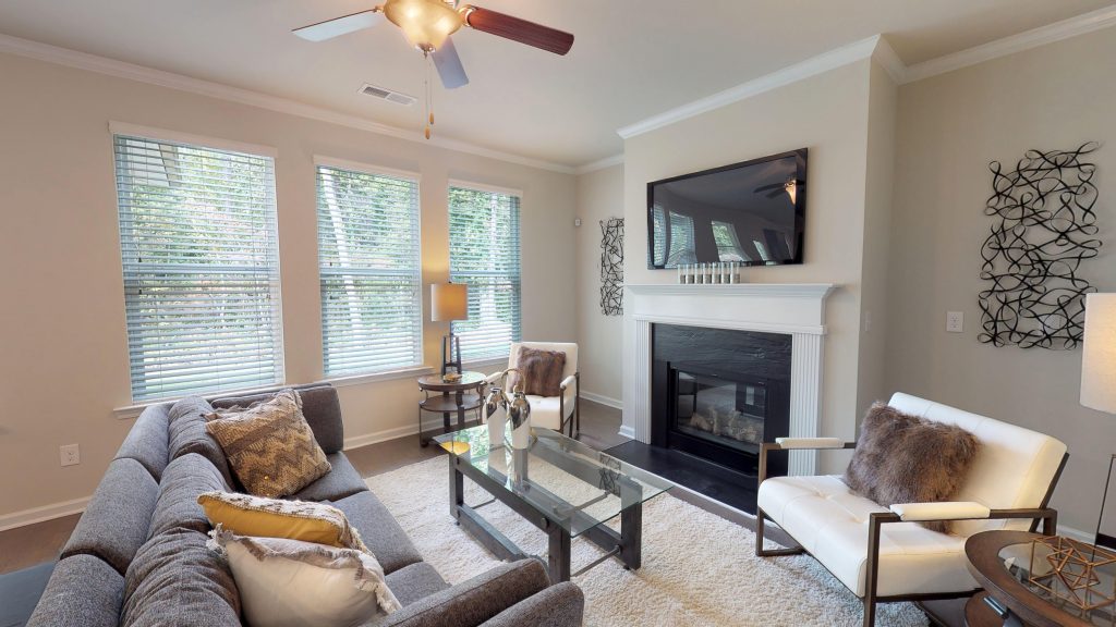 Decorating can be part of care for hardwood floors - seen here in Wynbrook floor plan home