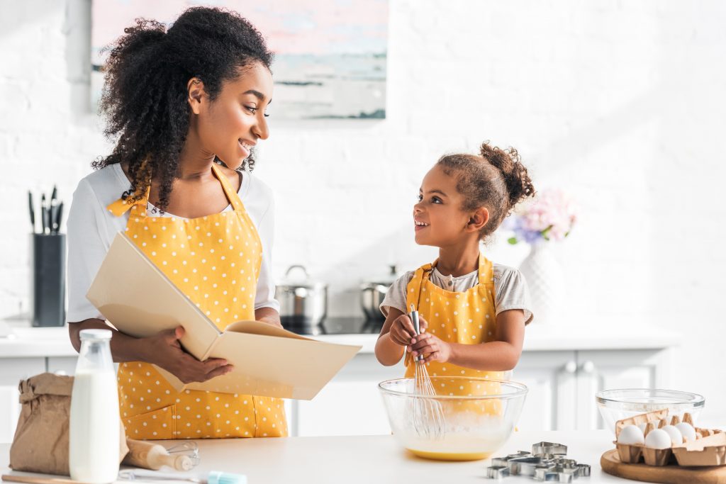 Mother and daughter baking together