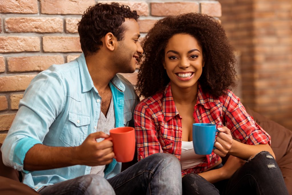 Couple drinking coffee on the front porch