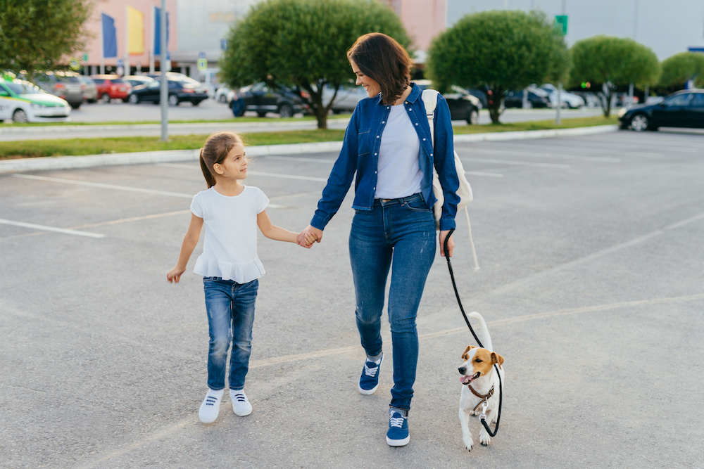 Mom and daughter walking dog ©StudioVK