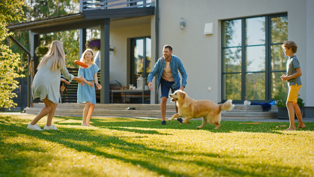 Family playing in the yard with dog