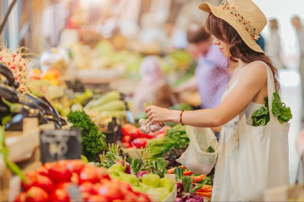 Woman browsing a farmers market ©Igisheva Maria