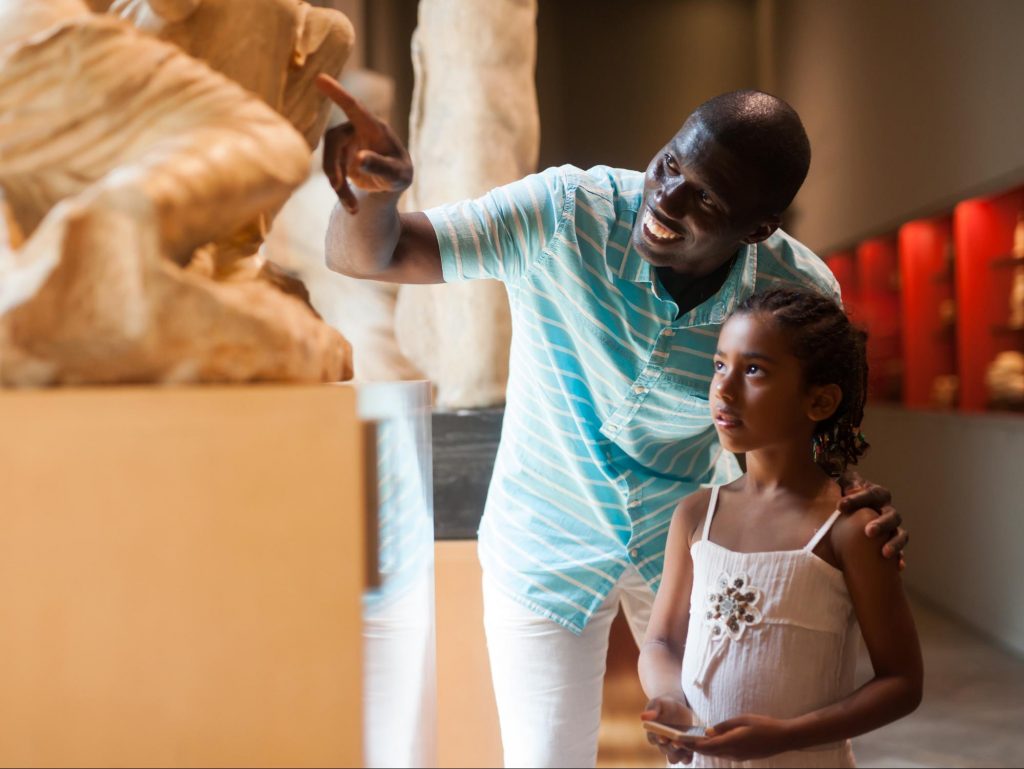 Father and Daughter at a museum looking at an exhibit ©BearFotos