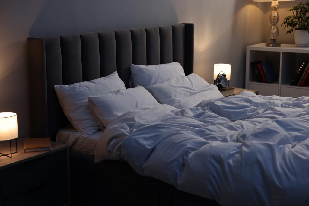 Guest bedroom in a basement home with bed and nightstands ©New Africa