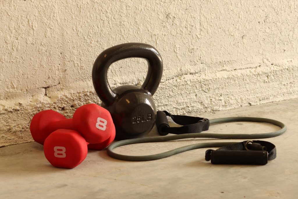 Home gym in an unfinished basement with workout equipment
©Jesse Case