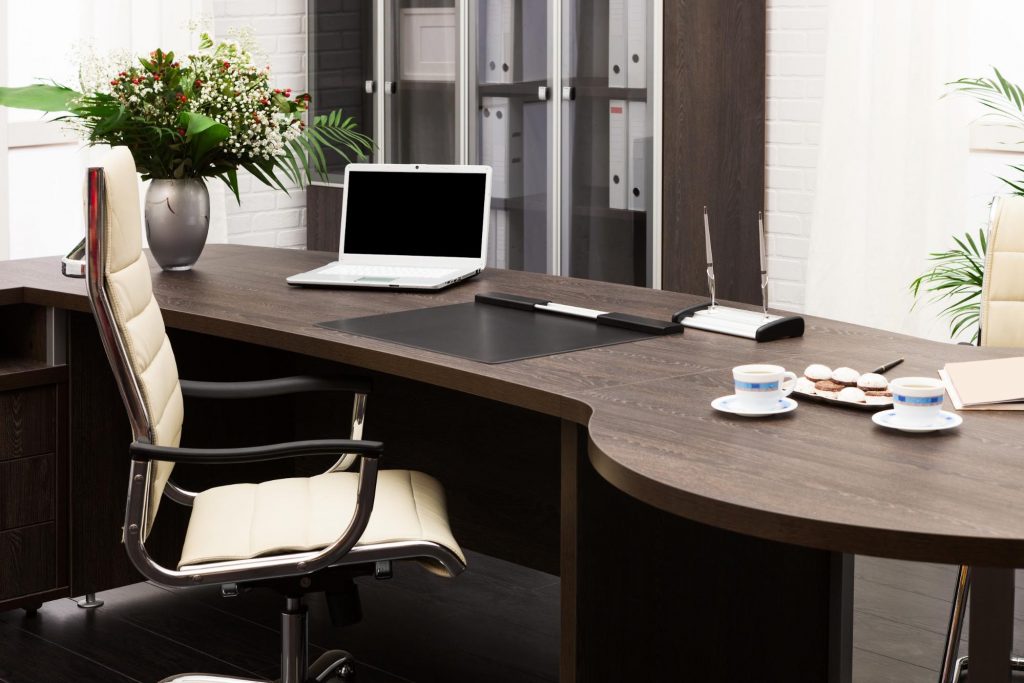 Home office setup in a finished basement with a desk and laptop ©terekhov igor