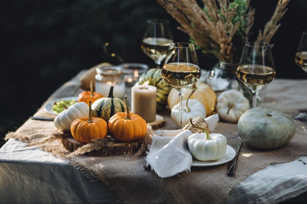 Elegant fall dinner party table with pumpkins and seasonal decor.
©Vera Prokhorova