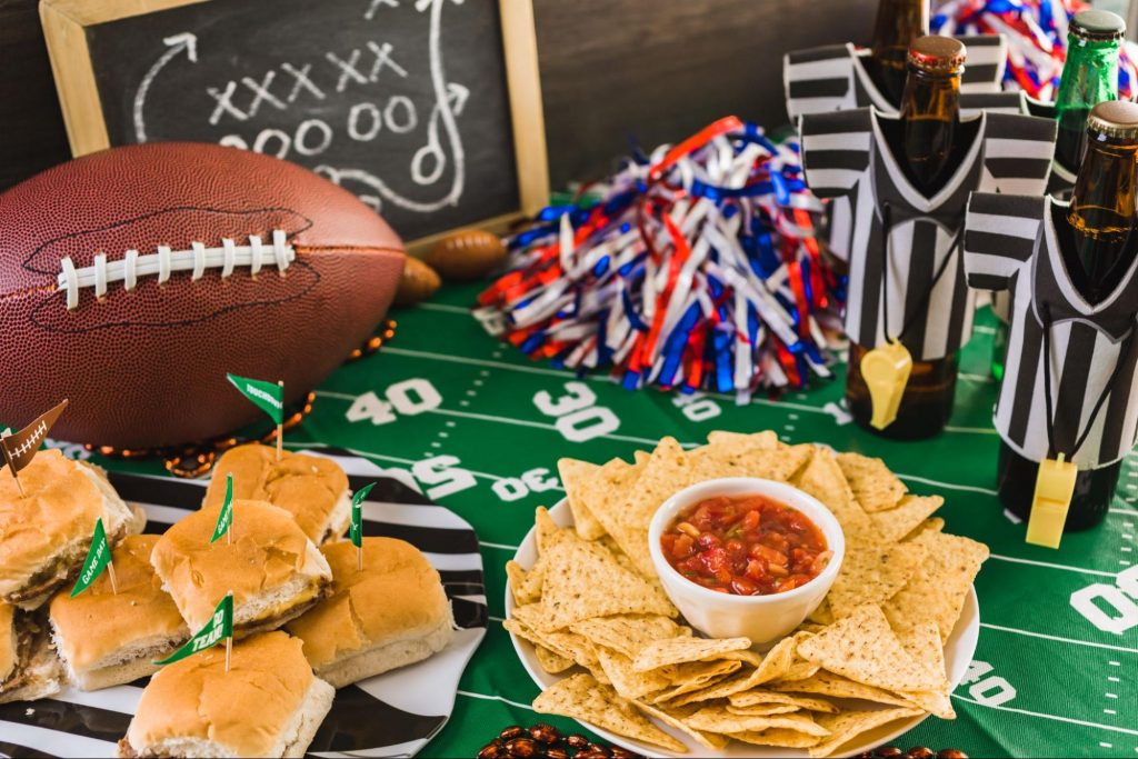 Football-themed snack spread with sliders, chips, and salsa.
©Arina P Habich