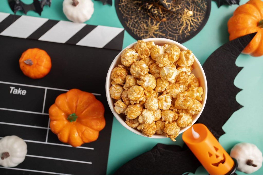 Halloween movie night setup with popcorn and themed decor.
©Yta23