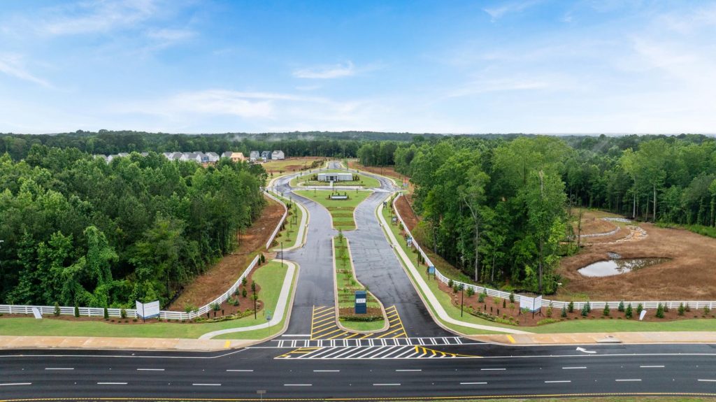 Aerial view of a master-planned community with landscaped streets and homes surrounded by trees.