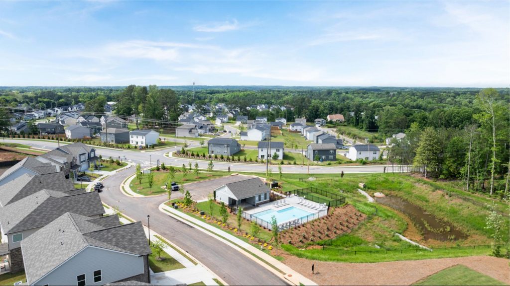 Aerial view of Alcovy Village community in Lawrenceville, GA showing homes, pool, and green spaces.