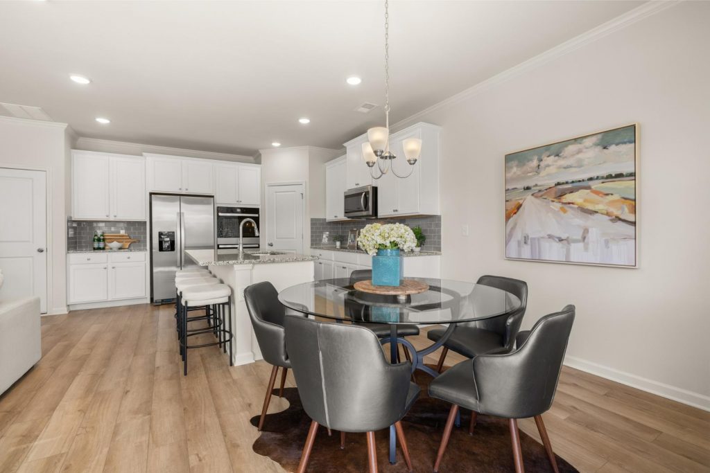 Gourmet kitchen at Alcovy Village with granite countertops, large island, and stainless steel appliances. 