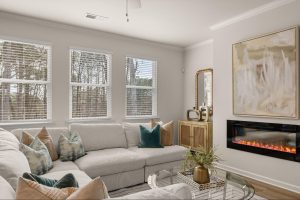 Living room with large windows and sectional sofa in Alcovy Village.