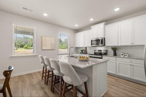 Modern white kitchen with granite island in Kingsmere Estates.