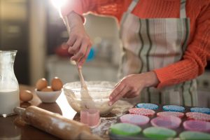 Someone mixing ingredients in a glass bowl while enjoying phone free activities in a gourmet kitchen. © Wavebreakmedia