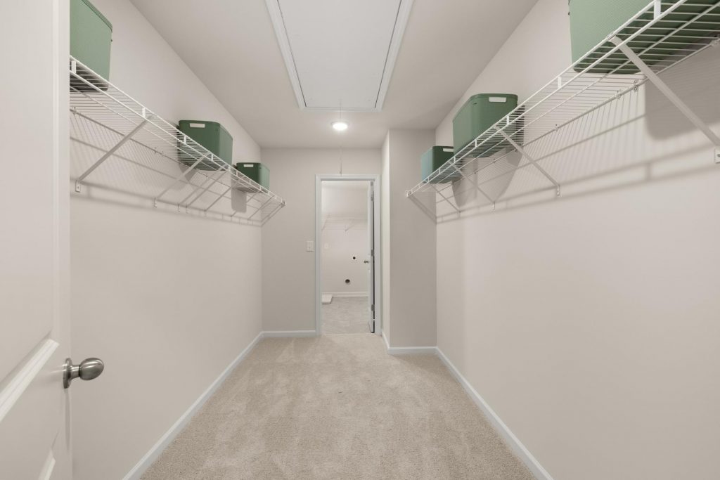 Spacious empty walk-in closet with efficient wire shelving.