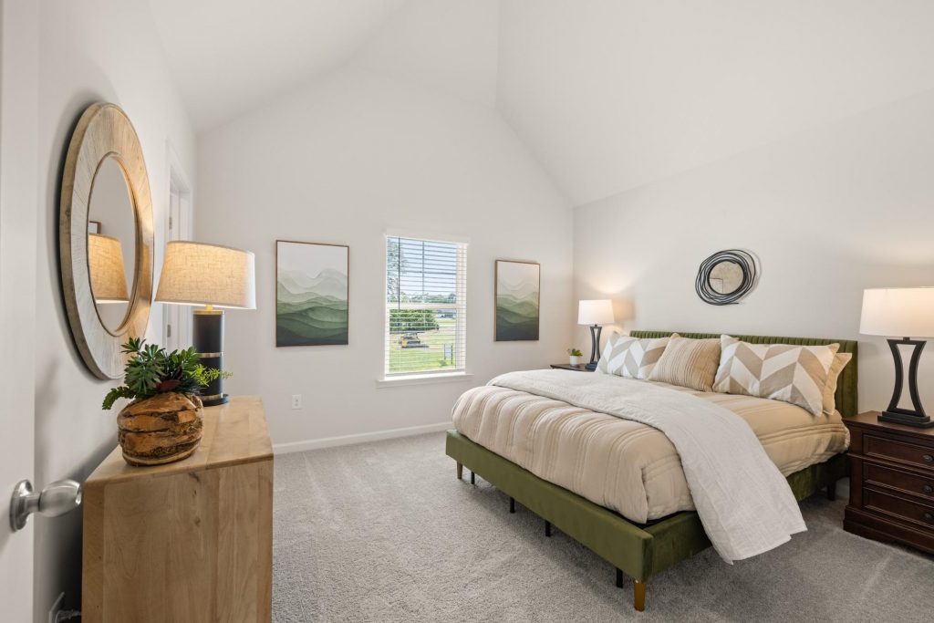 Airy bedroom with vaulted ceiling in a new Rockhaven home.
