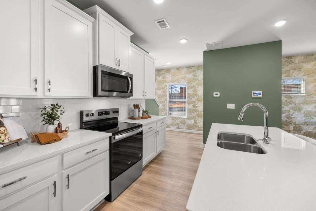 Modern white kitchen with stainless steel appliances at Lake Carlton.