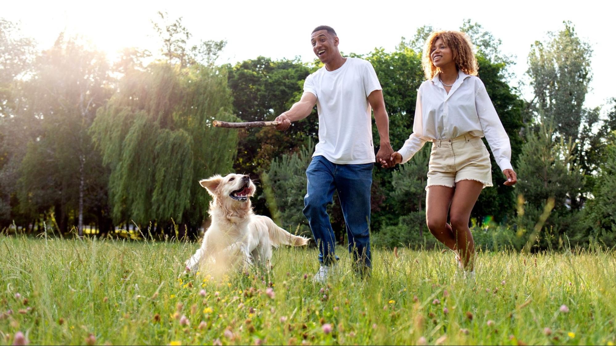 couple playing with dog ©Bohdan Malitskiy