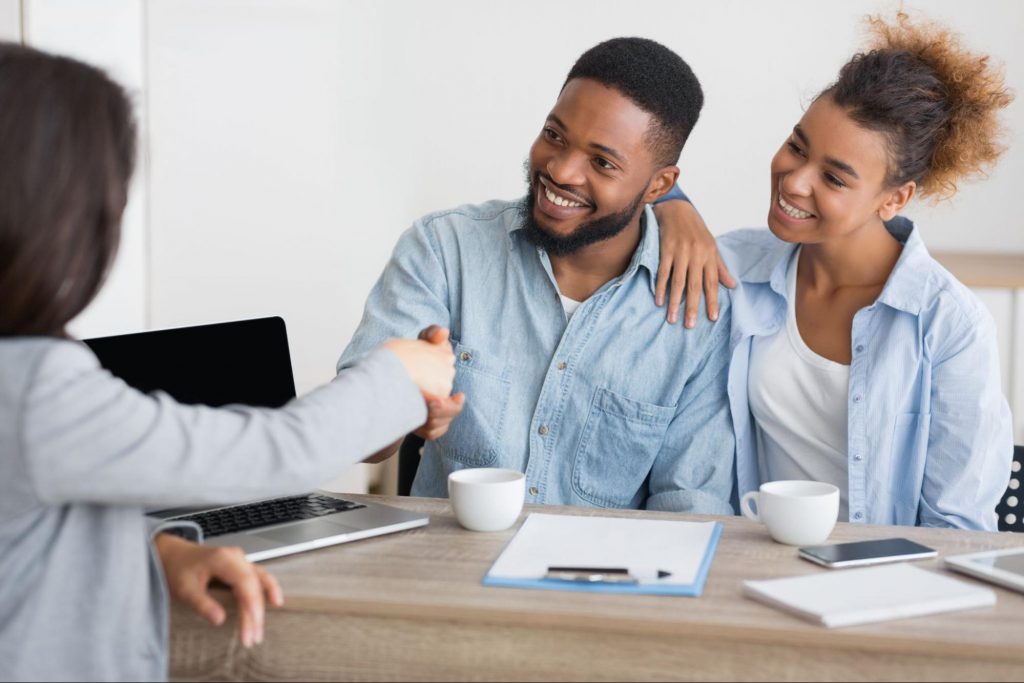 young couple meeting with a mortgage lender for a first-time homebuyer pre-approval in Georgia.
©Prostock-studio